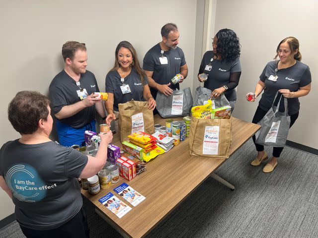 <p>Baycare Health Systems</p> Team members assembling Healing Bags at a BayCare location in 2024.