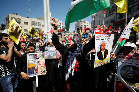 Demonstrators take part in a rally in support of Palestinian prisoners on hunger strike in Israeli jails, in the West Bank city of Ramallah April 17, 2017. REUTERS/Mohamad Torokman