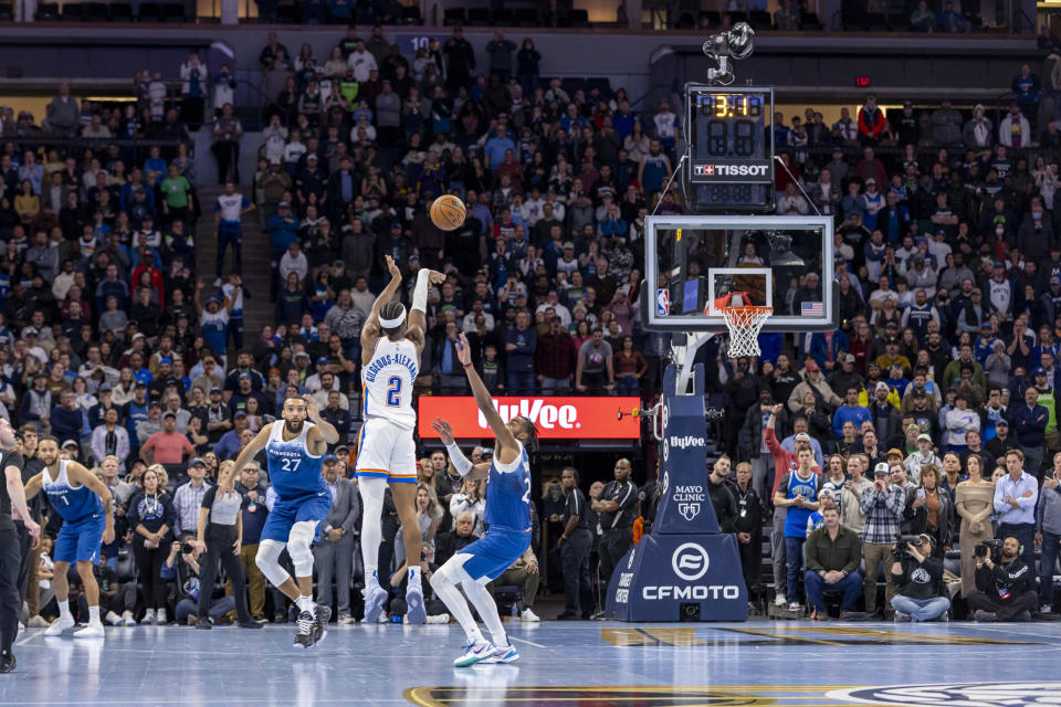 Nov 28, 2023; Minneapolis, Minnesota, USA; Oklahoma City Thunder guard Shai Gilgeous-Alexander (2) attempts a game trying shot as time expires in the fourth quarter over Minnesota Timberwolves forward Troy Brown Jr. (23) at Target Center. Mandatory Credit: Jesse Johnson-USA TODAY Sports