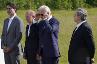 President Joe Biden, third from left, puts on his sunglasses as he stands with, from left, Canadian Prime Minister Justin Trudeau, German Chancellor Olaf Scholz, and Prime Minister of Italy Mario Draghi, during an event to formally launch the global infrastructure partnership, on the margins of the G7 Summit in Elmau, Germany, Sunday, June 26, 2022. (AP Photo/Susan Walsh)