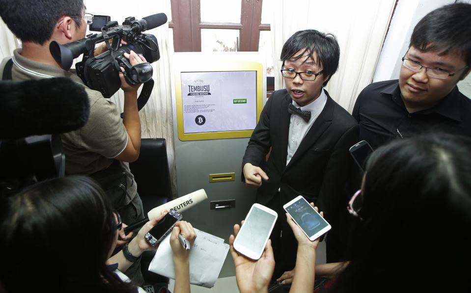 Tembusu Terminals' partners Peh and Luo speak to the media before launching the first Bitcoin vending machine at a pub in Singapore