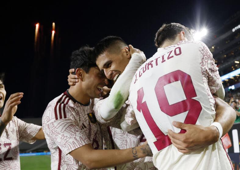 Guillermo Martinez of Mexico is congratulated by Omar Govea and Jordi Cortizo after scoring a goal against Colombia.