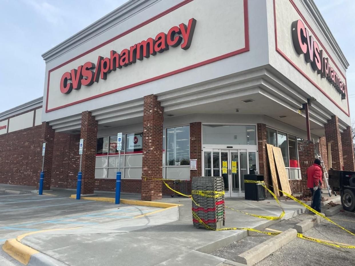 Repairs are made to the entrance of the 10th Street and Lapeer Avenue CVS in Port Huron on Friday, March 24, 2023, after a vehicle crashed into it earlier that afternoon.