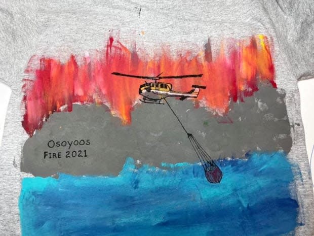 The wildfire-themed T-shirt created by Osoyoos, B.C.s Ayden McKillop, 7, has gone viral after his father Andrew posted photos to social media. (Andrew McKillop/Facebook - image credit)