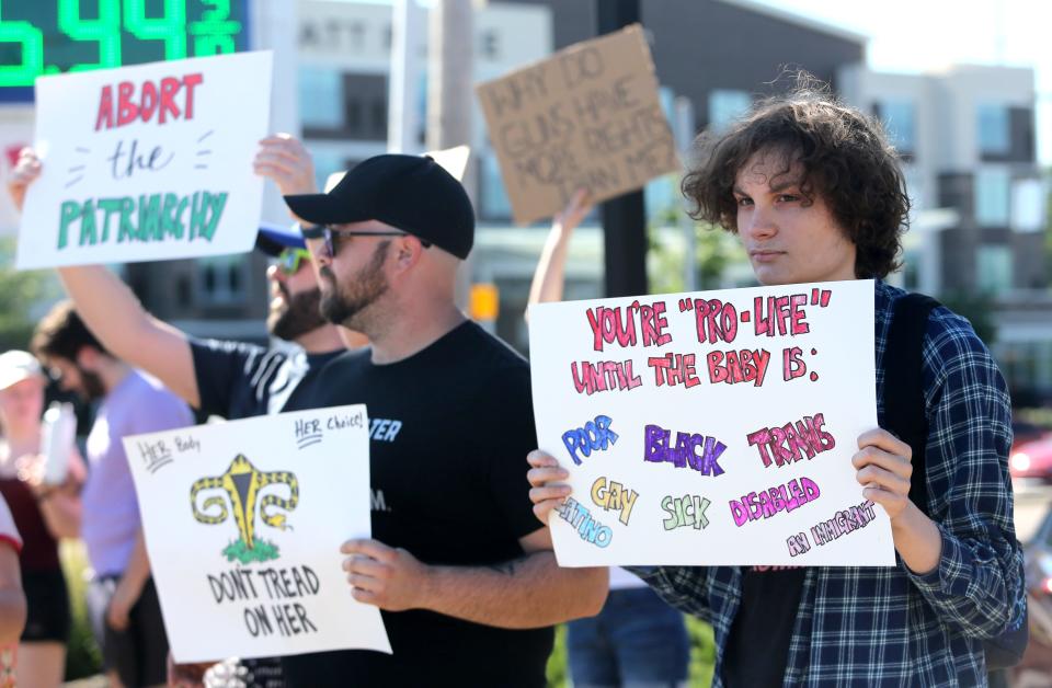 Mike Hardman, left, and his son Mike Hardman Jr. let their opinion be known during a protest in Plain Township after the U.S. Supreme Court overturned Roe v. Wade on Friday.