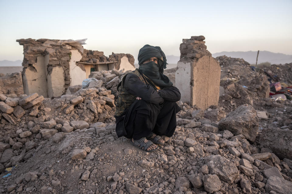 An Afghan sits by the rubble of his house earthquake in Zenda Jan district in Herat province, western of Afghanistan, Sunday, Oct. 8, 2023. Powerful earthquakes killed at least 2,000 people in western Afghanistan, a Taliban government spokesman said Sunday. It's one of the deadliest earthquakes to strike the country in two decades. (AP Photo/Ebrahim Noroozi)