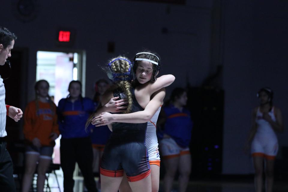 Olentangy Orange's Josie Nickoloff embraces Marysville's Annabelle Price after an OHSWCA girls wrestling state dual championship match Jan. 23.