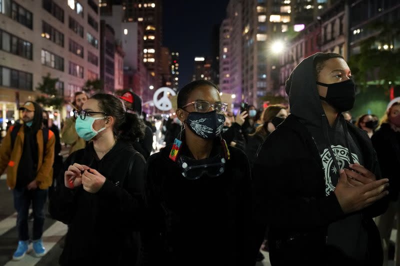 Demonstrators look on as they take part in the “People march because the fight continues" rally the day after Election Day in Manhattan, New York City