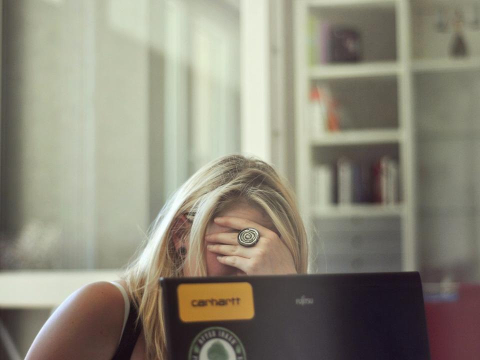 embarrassed exasperated frustrated woman laptop