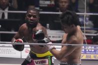 Boxer Floyd Mayweather of the U.S. throws a punch against mixed martial artist Mikuru Asakura of Japan in Saitama, north of Tokyo, Sunday, Sept. 25, 2022. (AP Photo/Hiro Komae)