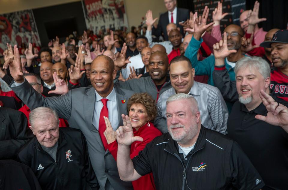 New University of Louisville men's basketball coach, Kenny Payne, takes a group photo with former players and coach Denny Crum after being introduced as the University of Louisville men's basketball coach. March 18, 2022