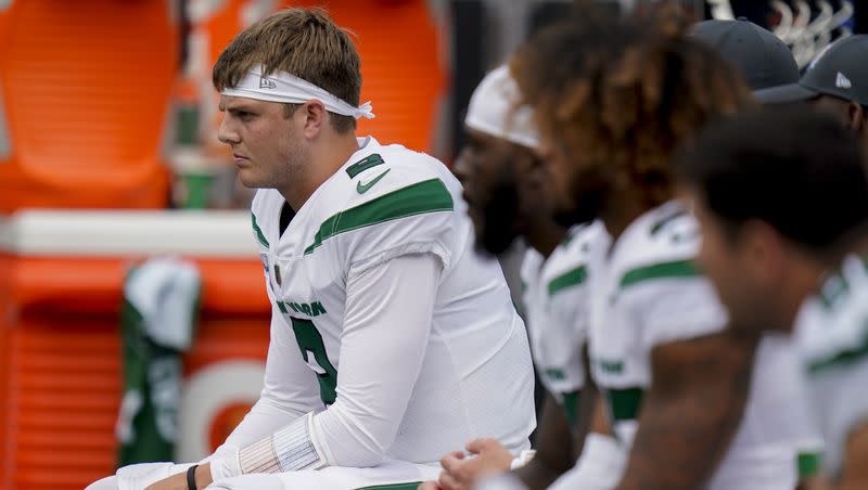 New York Jets quarterback Zach Wilson sits on the bench during an NFL football game against the Tennessee Titans on Oct. 3, 2021, in East Rutherford, N.J.