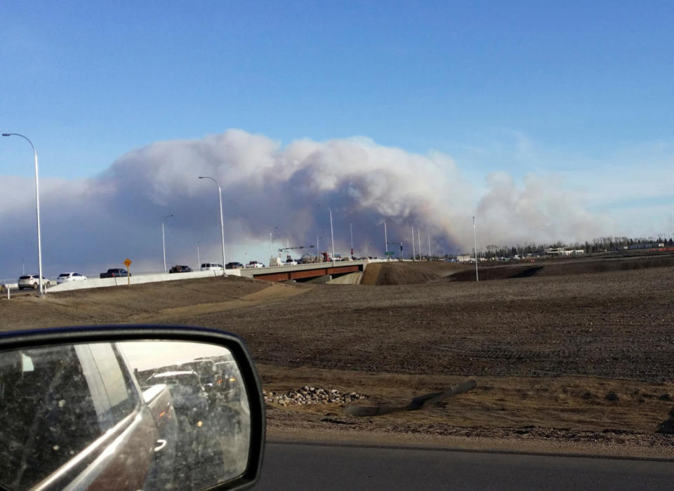 Vehicles are seen on highway 63 as they are detoured near wildfire burning near Fort McMurray, Alberta May 1, 2016. Gregory Hong/REUTERS