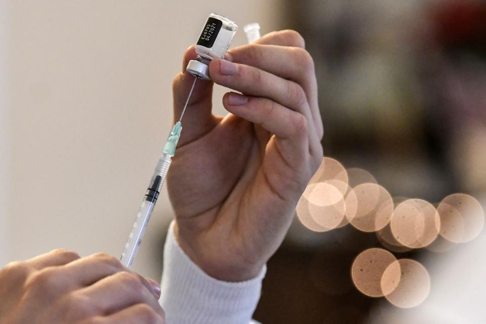 A nurse prepares a vaccine prior to the vaccination of elderly people at a nursing house in Athens, Monday, Jan. 4, 2021. Vaccinations were expanded from 9 to 50 hospitals nationwide on Monday. (Louisa Gouliamaki/Pool via AP)