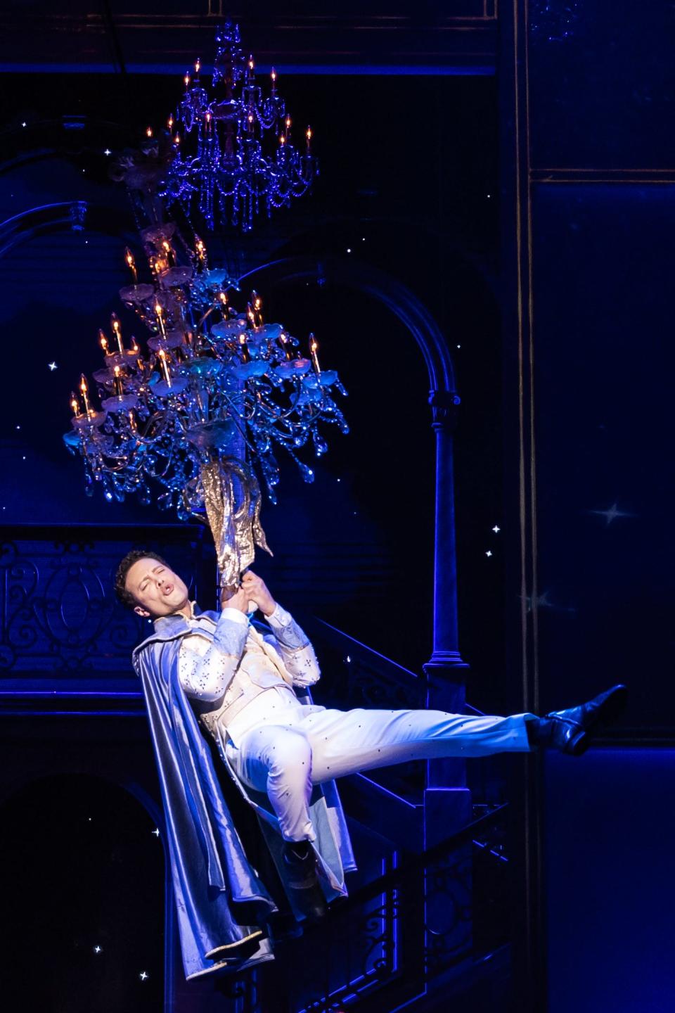 Justin Guarini swings from a chandelier as he sings Britney Spears' "Make Me..."