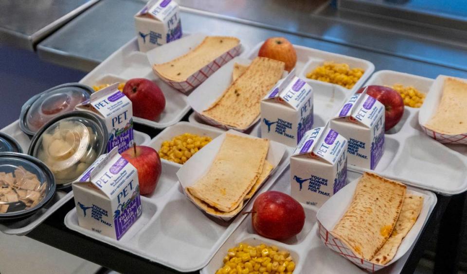 School lunches sit on a cart at Kingswood Elementary in Cary on Tuesday, June 4, 2024. Wake County school administrators briefed the school board Tuesday on a plan to potentially add 28 more schools to the federal government’s universal school meals program.