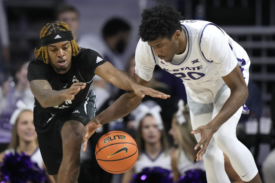 North Alabama guard Detalian Brown, left, and Kansas State forward Jerrell Colbert (20) chase after a loose ball during the first half of an NCAA college basketball game Saturday, Dec. 2, 2023, in Manhattan, Kan. (AP Photo/Charlie Riedel)