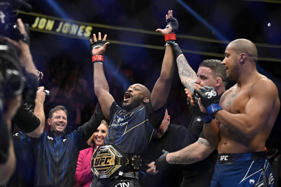 Jon Jones, center, celebrates after defeating Ciryl Gane in a UFC 285 mixed martial arts heavyweight title bout Saturday, March 4, 2023, in Las Vegas. (AP Photo/David Becker)