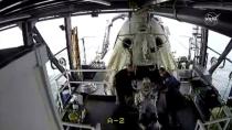 An opened hatch of a capsule carrying NASA astronauts Robert Behnken and Douglas Hurley is seen as one of the astronauts exits it in the Gulf of Mexico