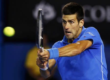 Novak Djokovic of Serbia hits a return to Andy Murray of Britain during their men's singles final match at the Australian Open 2015 tennis tournament in Melbourne February 1, 2015. REUTERS/Issei Kato