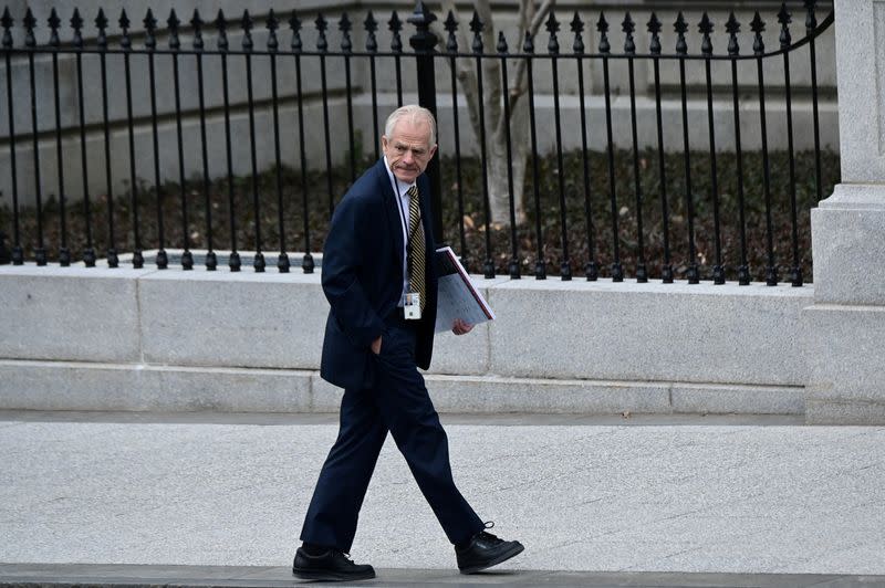 FILE PHOTO: White House advisor Peter Navarro leaves the West Wing carrying a poster board displaying claims of voting irregularity at the White House in Washington