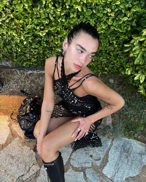 <p>Dua Lipa spent the weekend in Portofino, Italy, for the latest leg of her Future Nostalgia tour – and dressed for the occasion in a black fishnet minidress covered in silver sequins. The singer went full summer goth, completing the look with Balenciaga's black leather Cagole boots and matching handbag. </p><p><a href="https://www.instagram.com/p/CeGuUZZsi_x/" rel="nofollow noopener" target="_blank" data-ylk="slk:See the original post on Instagram;elm:context_link;itc:0;sec:content-canvas" class="link ">See the original post on Instagram</a></p>