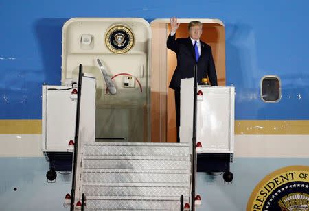 U.S. President Donald Trump waves upon his arrival at Paya Lebar Air Base in Singapore, before his summit with North Korean leader Kim Jong Un, June 10, 2018. REUTERS/Kim Kyung-Hoon