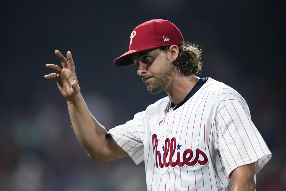 Philadelphia Phillies pitcher Aaron Nola waves to the crowd after being pulled during the eighth inning of a baseball game against the Milwaukee Brewers, Tuesday, July 18, 2023, in Philadelphia. (AP Photo/Matt Slocum)