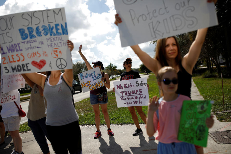 <p>People holding placards take part in a protest in support of the gun control in Coral Springs, Fla., Feb. 17, 2018. (Photo: Carlos Garcia Rawlins/Reuters) </p>