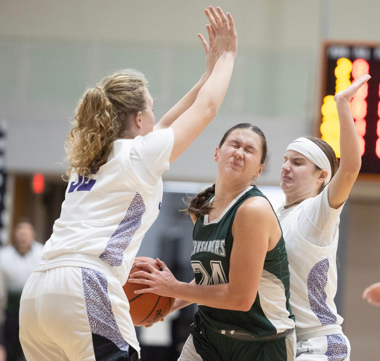 Central Catholic's Lily Belden works to split the defense of Jackson's Alexa Pizor (32) and Ashley Helle (23) in the second half of Wednesday's game.