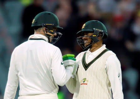 Australia v South Africa - Third Test cricket match - Adelaide Oval, Adelaide, Australia - 25/11/16. Australian batsman Peter Handscomb (L) reacts with team mate Usman Khawaja after Handscombe scored 50 runs during the second day of the Third Test cricket match in Adelaide. REUTERS/Jason Reed