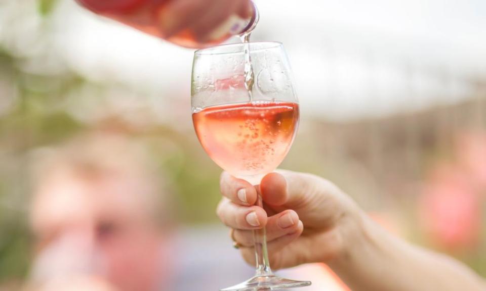 Woman pouring glass of wine outdoors