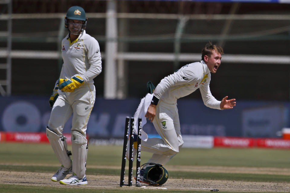 Australia's Marnus Labuschagne, right, and Alex Carey celebrate the dismissal of Pakistan's Abdullah Shafique during the third day of the second test match between Pakistan and Australia at the National Stadium in Karachi, Pakistan, Monday, March 14, 2022. (AP Photo/Anjum Naveed)