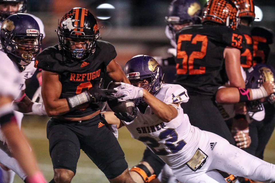 Shiner's Beck Bishop attempts to tackle Refugio's Kaleb Brown on Friday, Oct. 21, 2022, at Bobcat Stadium in Refugio, Texas.