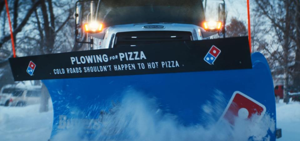 Domino's is helping select cities with $25,000 snow plowing grants.
