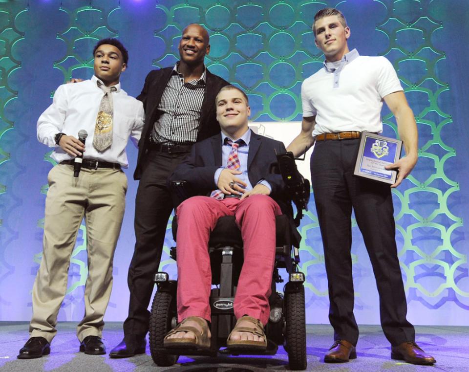 Cathedral Prep's Ian Malesiewski, center, is presented the Inspirational Athlete of the Year award during the Best of Varsity Cup awards dinner June 23, 2017, at the Bayfront Convention Center. With Ian are classmate Dazjon Casto, left, former Pittsburgh Steelers linebacker Ryan Shazier, center, and Ian's brother, Adam Malesiewski, right.