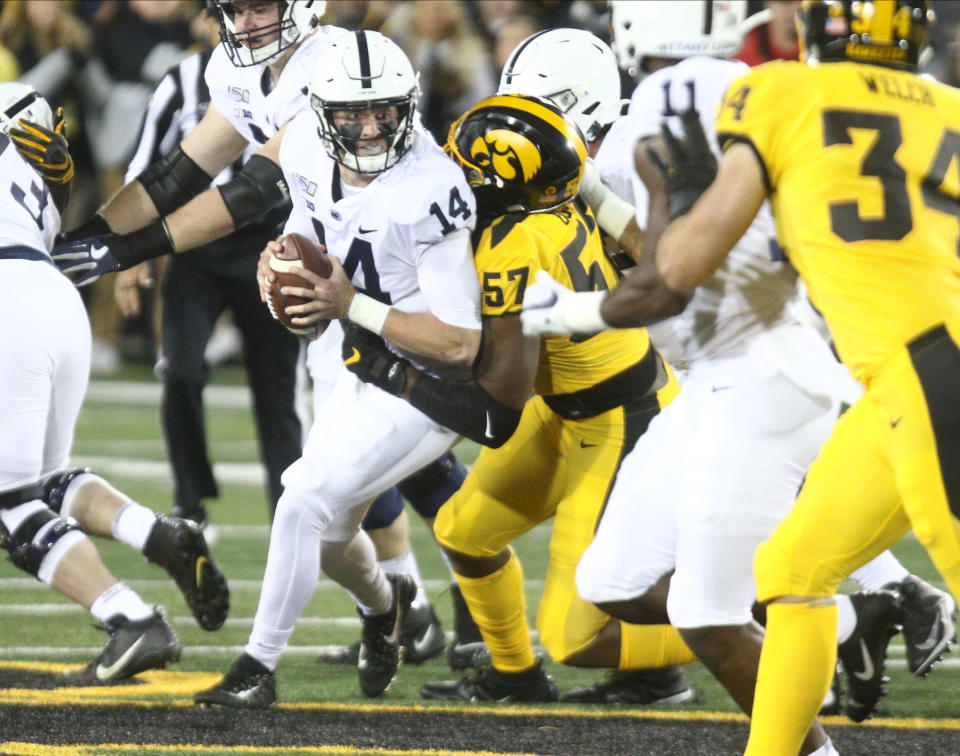 IOWA CITY, IOWA- OCTOBER 12:  Quarterback  Sean Clifford #14 of the Penn State Nittany Lions is sacked in the first half by defensive lineman Chauncey Golston #57 of the Iowa Hawkeyes, on October 12, 2019 at Kinnick Stadium in Iowa City, Iowa.  (Photo by Matthew Holst/Getty Images)