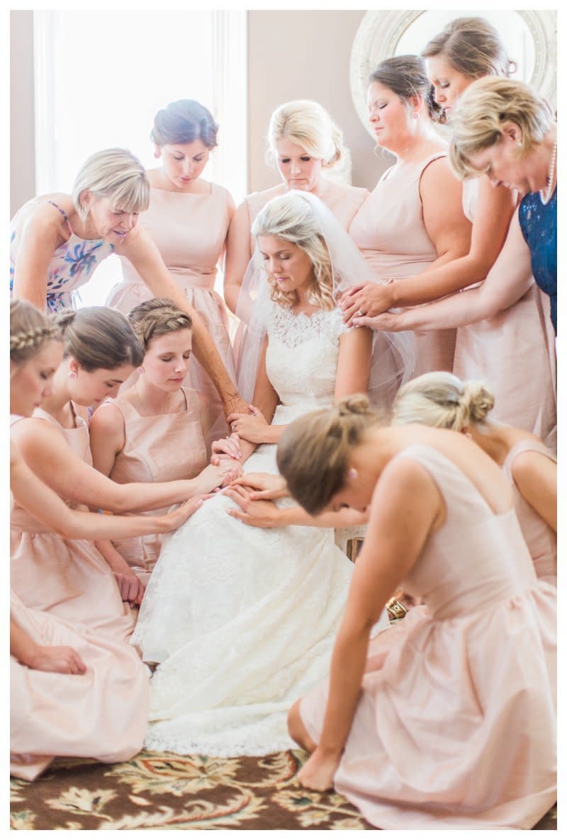 <p>"All the bridesmaids and the mother of the bride and groom gathered around this sweet bride and prayed over her. It was so genuine, sweet and powerful. The fact that each person took the time to say their own little prayer made it so personal." - Nicole Moering</p>