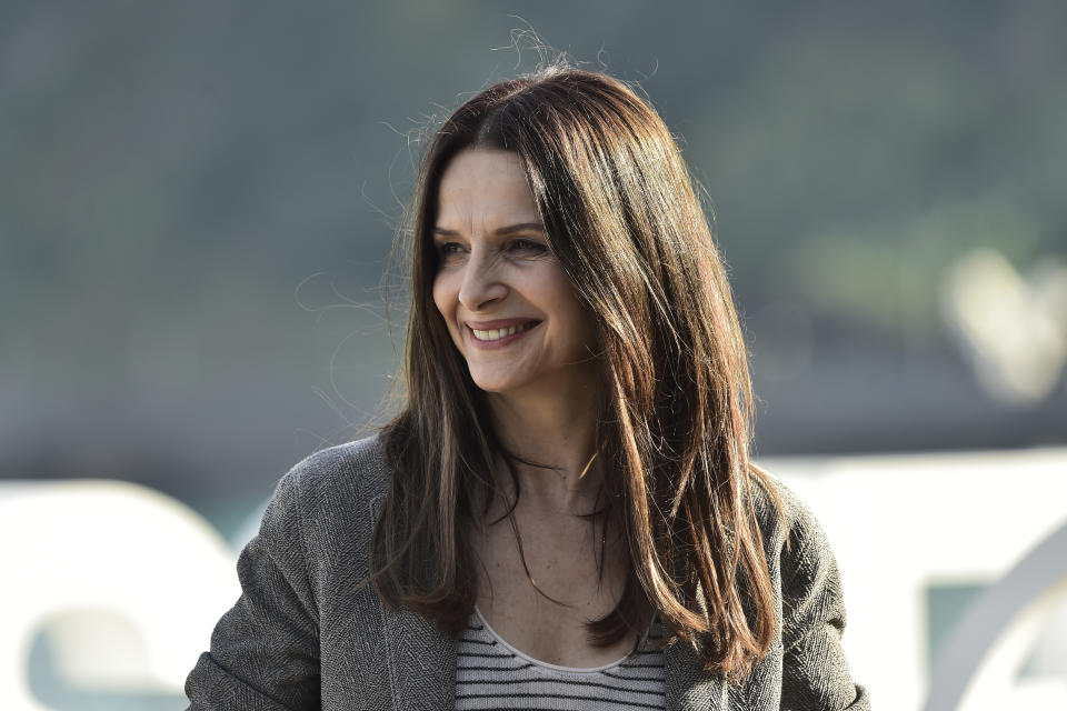 FILE - Actress Juliette Binoche poses during a photo-call at the 70th San Sebastian Film Festival, in San Sebastian, northern Spain, Sunday, Sept. 18, 2022. Oscar-winning actresses Marion Cotillard and Juliette Binoche, as well as other French stars of screen and music, filmed themselves chopping off locks of their hair in a video posted Wednesday in support of protesters in Iran. (AP Photo/Alvaro Barrientos, File)