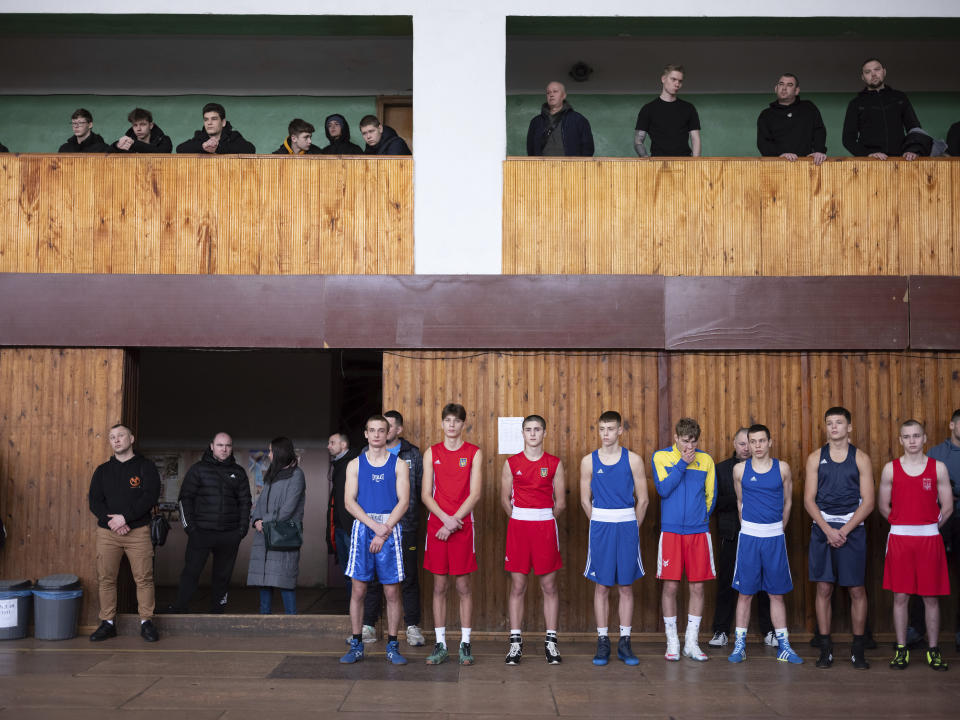 Young boxers stand during the official opening of a boxing tournament in honor of Maksym Halinichev, who was killed during fighting with Russian forces in March 2023, in Romny, Sumy region, Ukraine on Saturday, Feb. 3, 2024. (AP Photo/Evgeniy Maloletka)