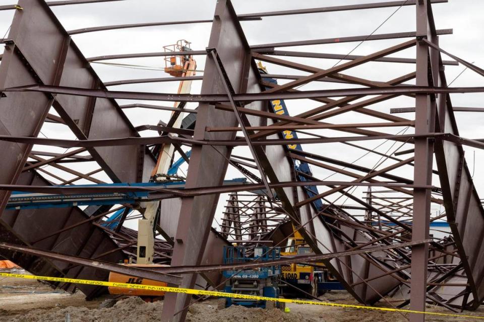 At the construction site where a building collapsed Wednesday near the Boise Airport, wreckage shows twisted girders with a crane in the center. Three workers died at the scene and nine others were injured. The project was an airplane hangar for Jackson Jet Center.