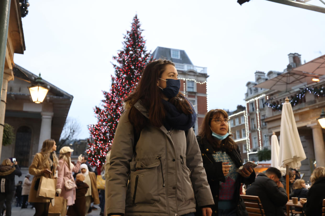 People wearing facemasks in London's Covent Garden, after new restrictions have come into force to slow the spread of the Omicron variant of coronavirus. Picture date: Thursday December 16, 2021.