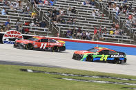 Denny Hamlin (11) and William Byron (24) drive during a NASCAR Cup Series auto race at Texas Motor Speedway Sunday, Oct. 17, 2021, in Fort Worth, Texas. (AP Photo/Randy Holt)