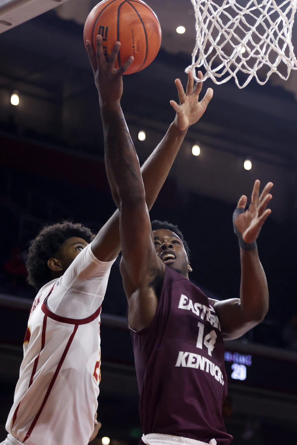 Eastern Kentucky forward Devontae Blanton (14) goes to basket while defended by Southern California forward Max Agbonkpolo (23) during the second half of an NCAA college basketball game Tuesday, Dec. 7, 2021, in Los Angeles. USC won 80-68. (AP Photo/Ringo H.W. Chiu)