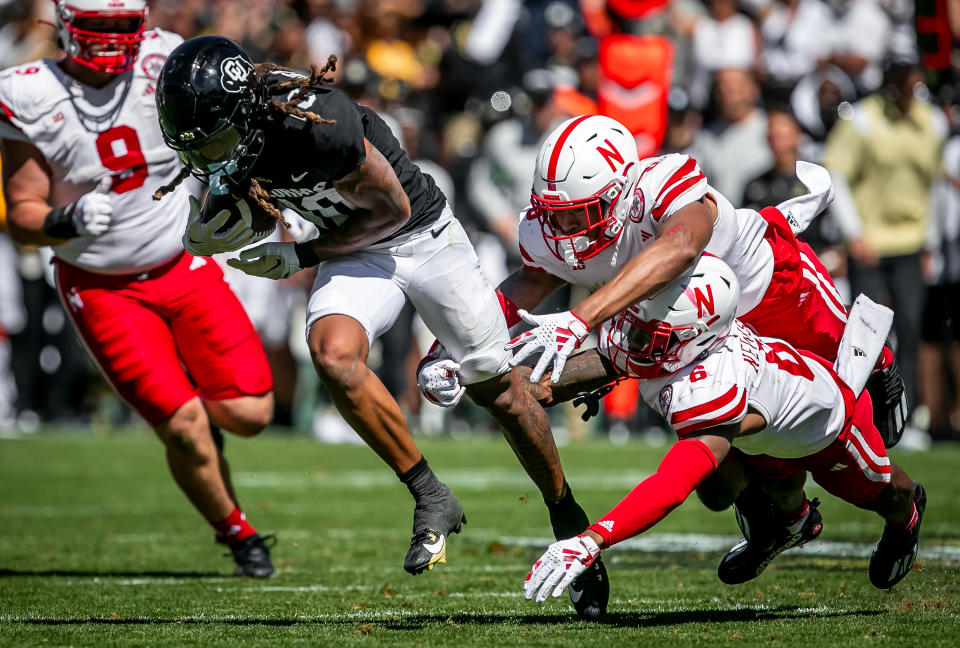 BOULDER, CO - SEPTEMBER 09: Colorado wide receiver Xavier Weaver (10) attempts to split the tackle of Nebraska Defensive back Quinton Newsome (6) and Defensive back DeShon Singleton (8) during the home opener game between the Colorado Buffaloes and the the Nebraska Cornhuskers on Saturday, September 9, 2023 at Folsom Field in Boulder, CO.  (Photo by Nick Tre. Smith/Icon Sportswire via Getty Images)