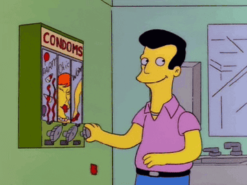 Animated character selecting a product from a vending machine labeled "condoms" in a humorous context