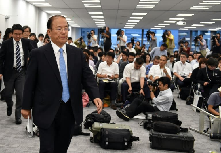 Toshiro Muto (2nd L), chief executive officer of the Tokyo Organising Committee of the Olympic and Paralympic Games, enters a press conference on September 1, 2015
