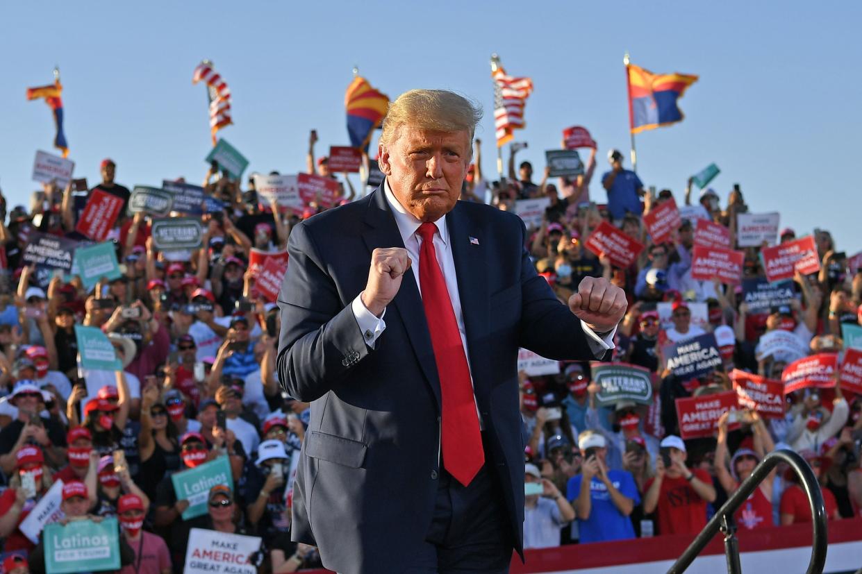 <p>US President Donald Trump dances as he leaves a rally at Tucson International Airport in Tucson, Arizona on October 19, 2020.</p> (Photo by MANDEL NGAN/AFP via Getty Images)