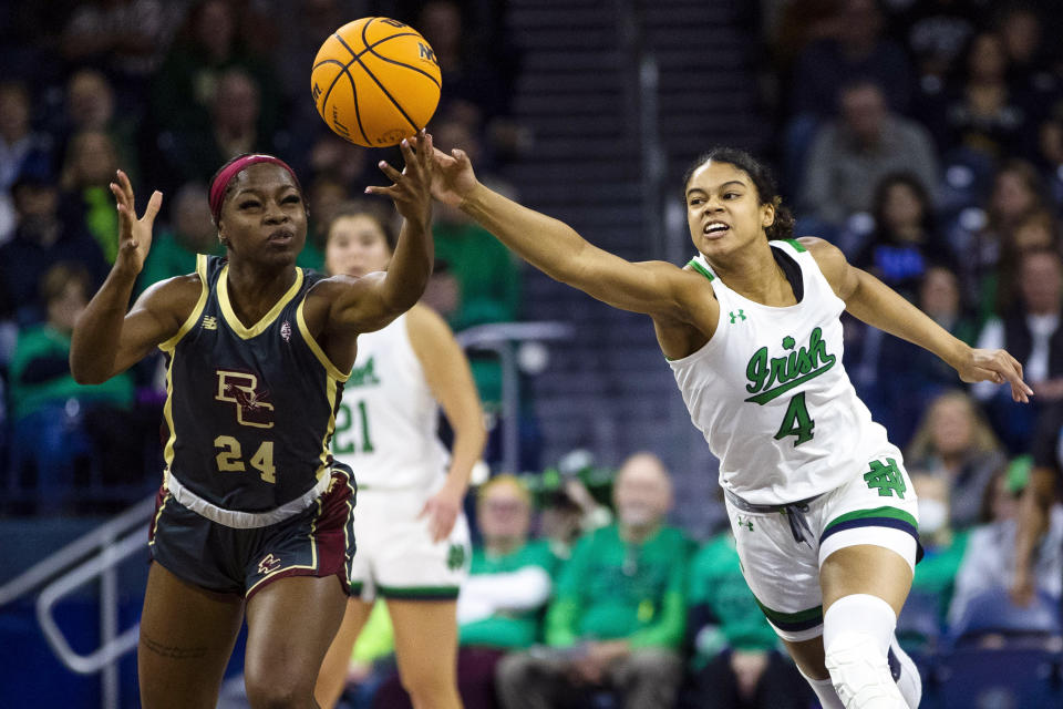 Notre Dame's Cassandre Prosper (4) knocks the ball away from Boston College's Dontavia Waggoner (24) during the first half of an NCAA college basketball game Sunday, Jan. 1, 2023 in South Bend, Ind. (AP Photo/Michael Caterina)