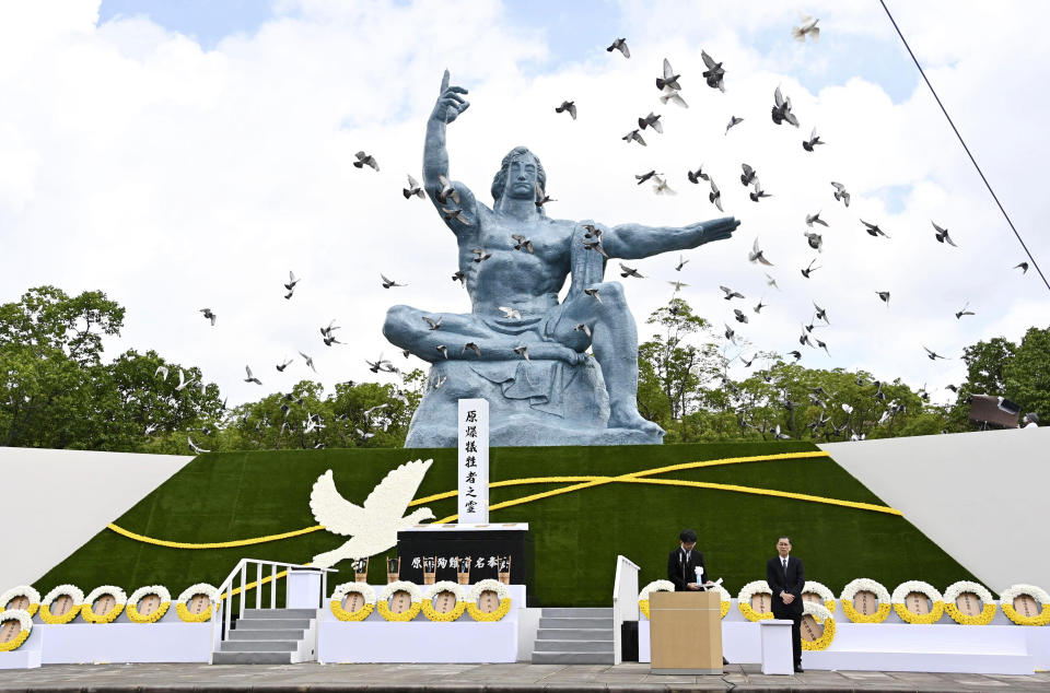 Doves fly over the Statue of Peace during a ceremony at Nagasaki Peace Park in Nagasaki, southern Japan Sunday, Aug. 9, 2020, to mark the 75th anniversary of the world's second atomic bomb attack. (Kyodo News via AP)